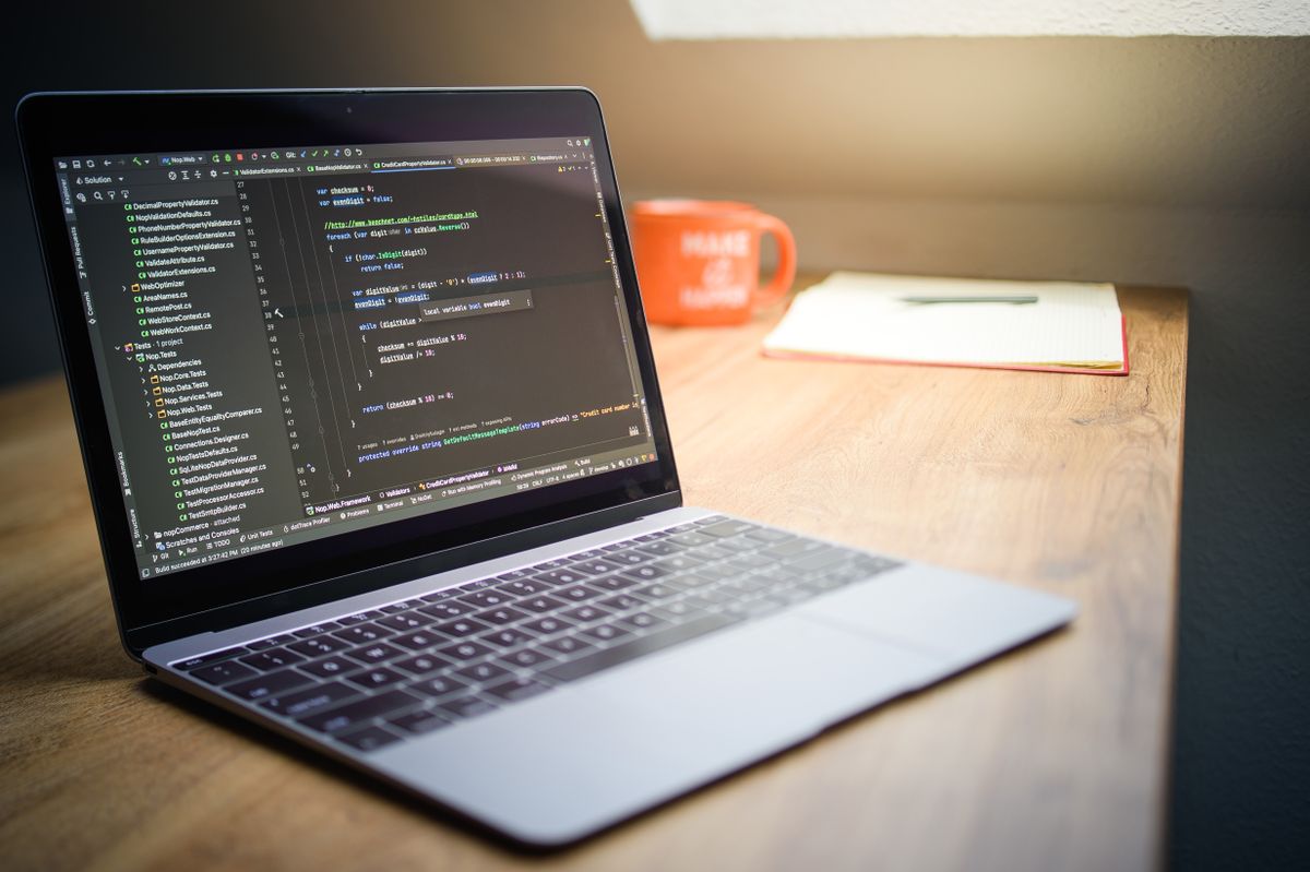 Modern workspace with laptop and code on screen