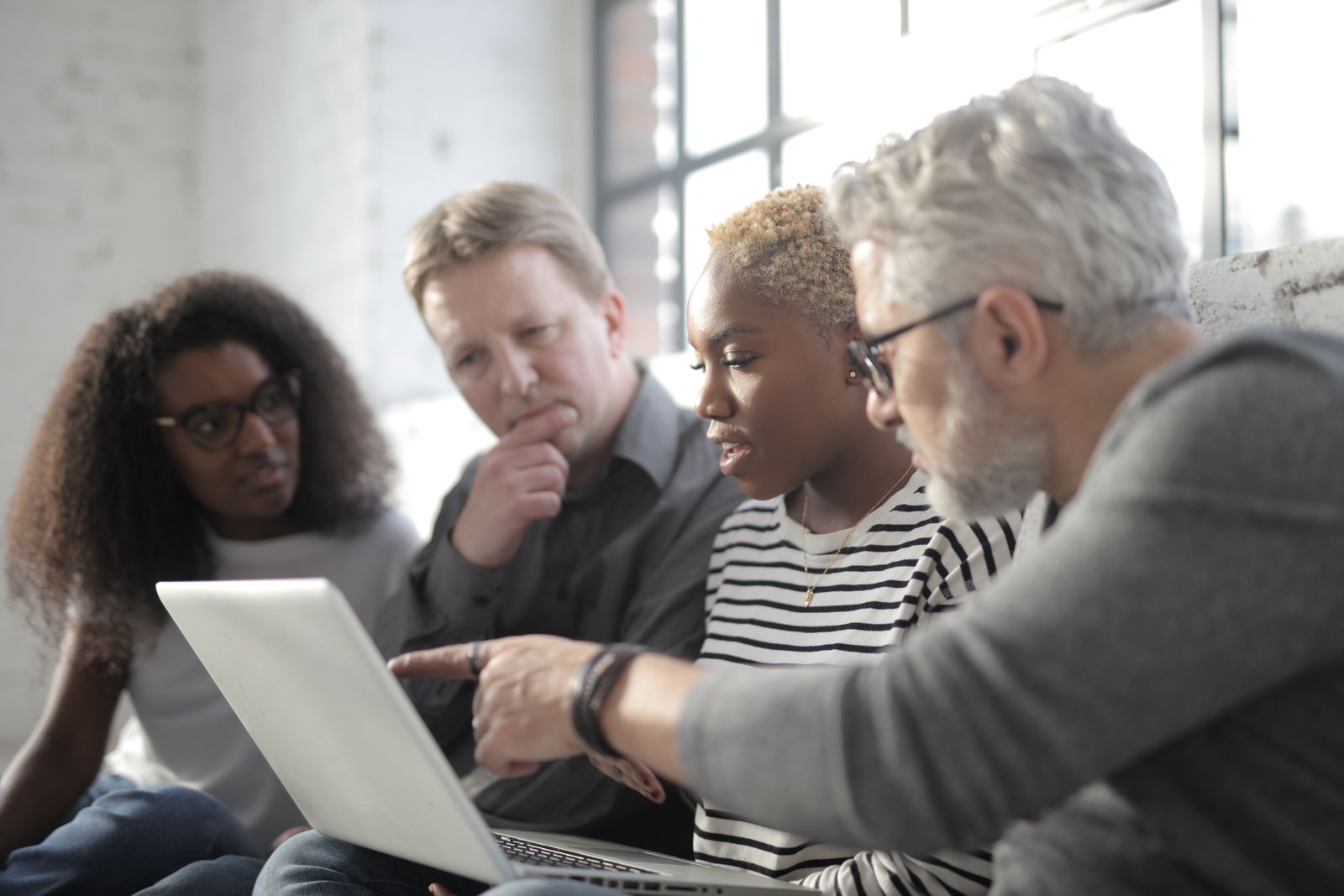 Team reviewing a project together on a laptop